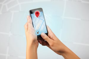 Female fingers touching smartphone with map-1