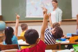 Pupils raising hand during geography lesson in classroom at the elementary school-1