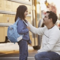 father-saying-goodbye-to-daughter-in-front-of-school-bus-1-400296-edited